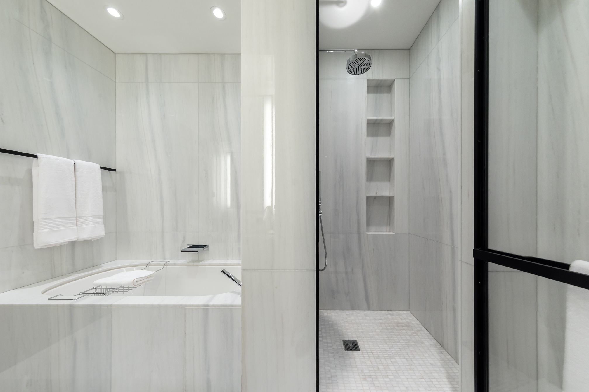 157 West 57th Street, Unit 32T Manhattan, NY 10019 - Photo 5 of 11 a bathroom with a bathtub and a shower