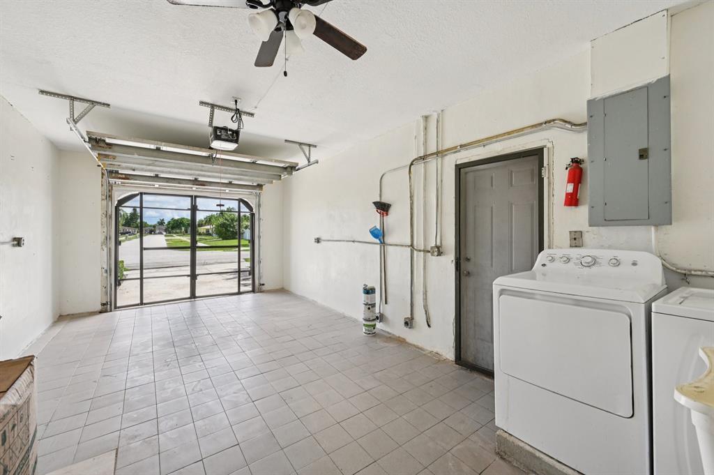 4549 Baldric Street Boca Raton, FL 33428 - Photo 21 of 43 a view of hallway with washer and dryer
