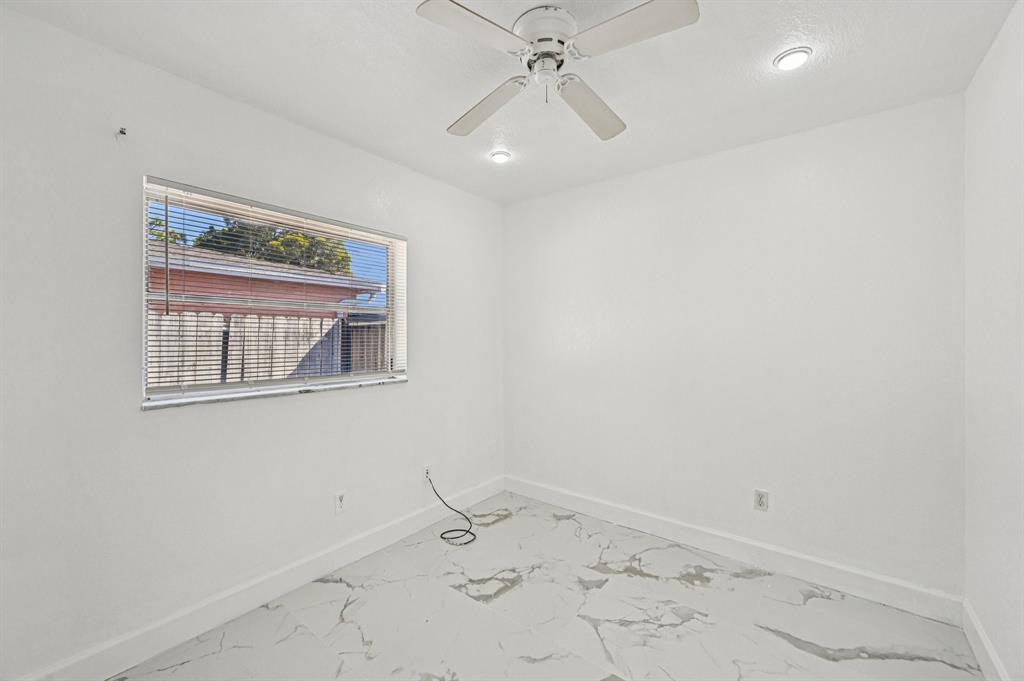 4549 Baldric Street Boca Raton, FL 33428 - Photo 25 of 43 an empty room with a window and chandelier fan