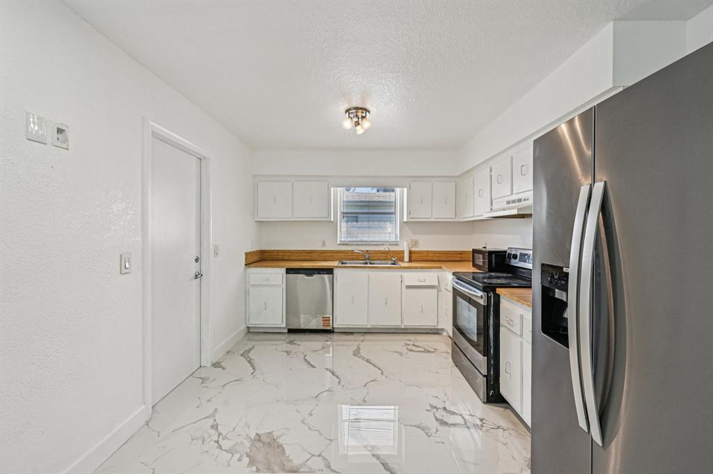 4549 Baldric Street Boca Raton, FL 33428 - Photo 29 of 43 a kitchen with stainless steel appliances a refrigerator sink and stove