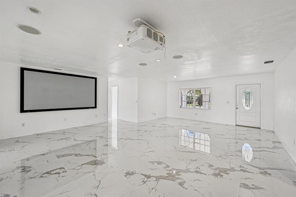 4549 Baldric Street Boca Raton, FL 33428 - Photo 35 of 43 a view of a hallway with paintings on the wall