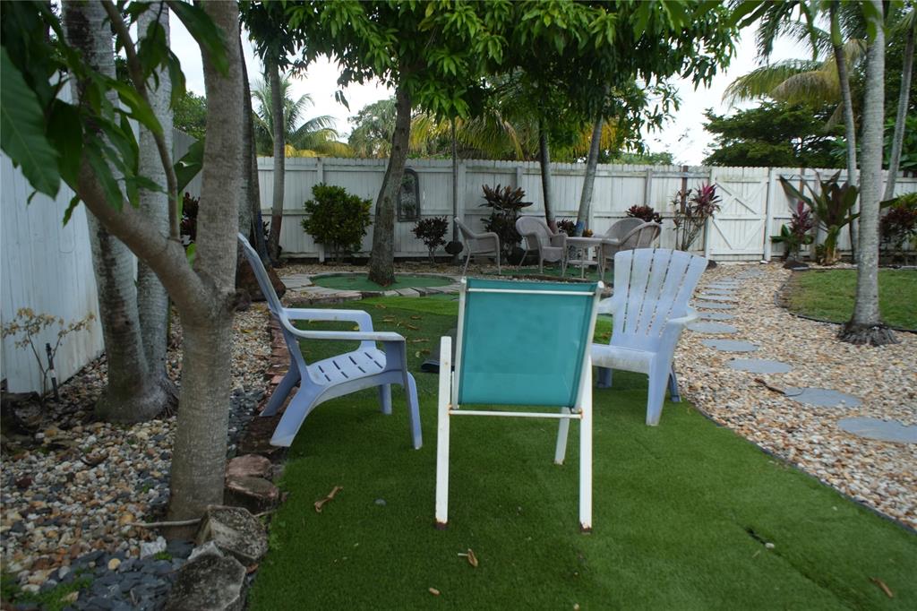 4549 Baldric Street Boca Raton, FL 33428 - Photo 5 of 43 a view of a chair and table in backyard
