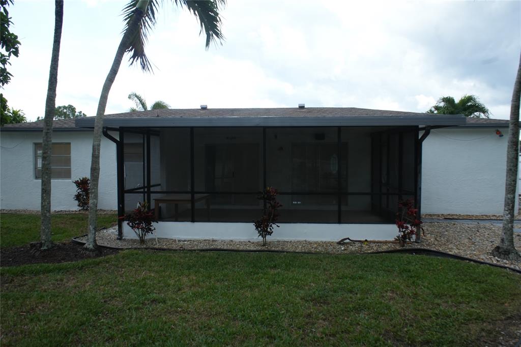 4549 Baldric Street Boca Raton, FL 33428 - Photo 7 of 43 a backyard of a house with lots of green space