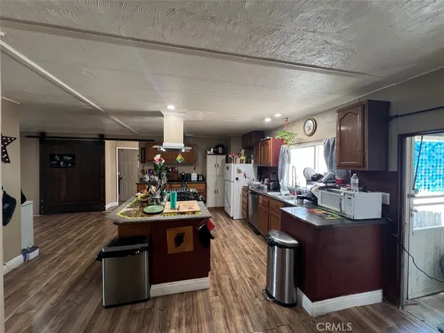 a kitchen island with granite countertop lots of counter top space and stainless steel appliances