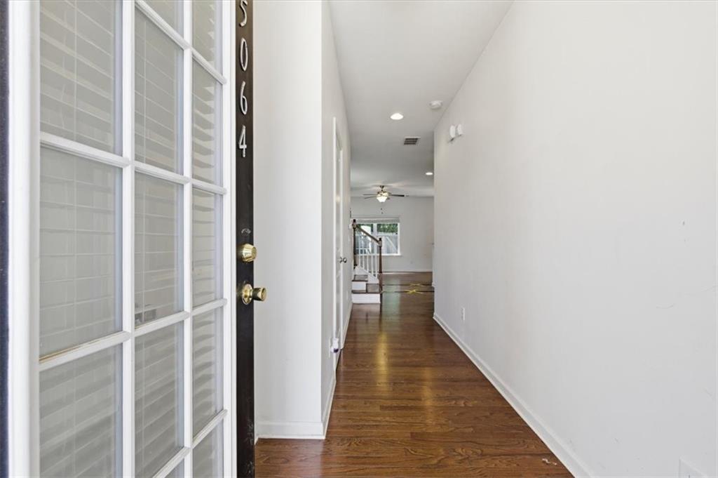 5064 Longview Walk Decatur, GA 30035 - Photo 7 of 30 a view of a hallway with wooden floor and staircase