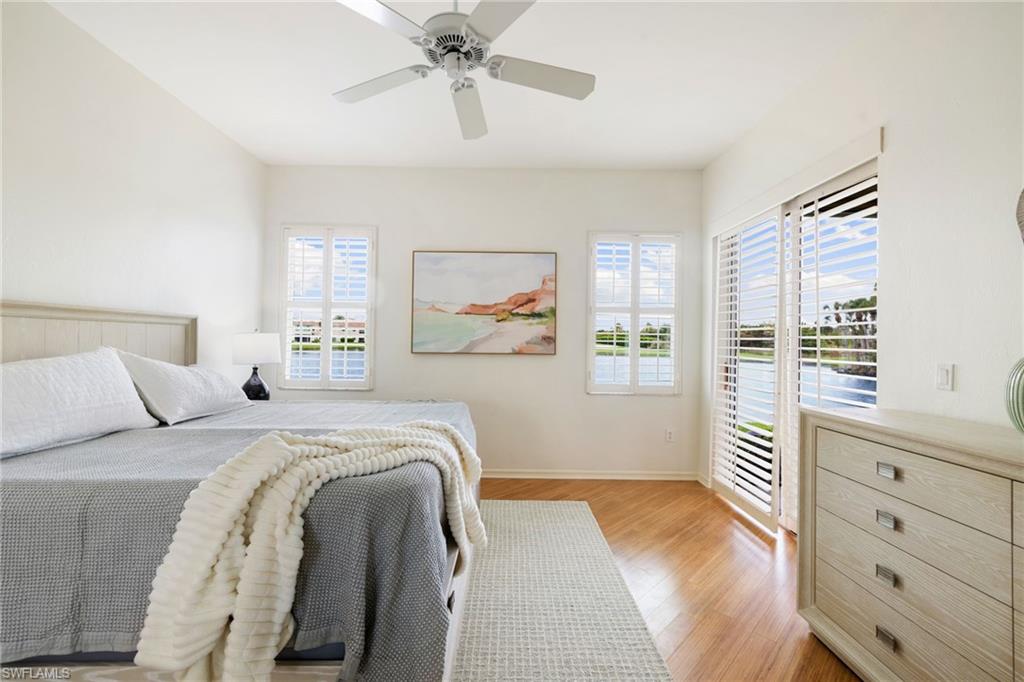 2153 Paget Circle Naples, FL 34112 - Photo 15 of 49 Bedroom featuring access to exterior, light wood-style flooring, and ceiling fan