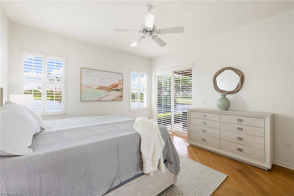 2153 Paget Circle Naples, FL 34112 - Photo 16 of 49 Bedroom with access to outside, multiple windows, wood finished floors, and ceiling fan