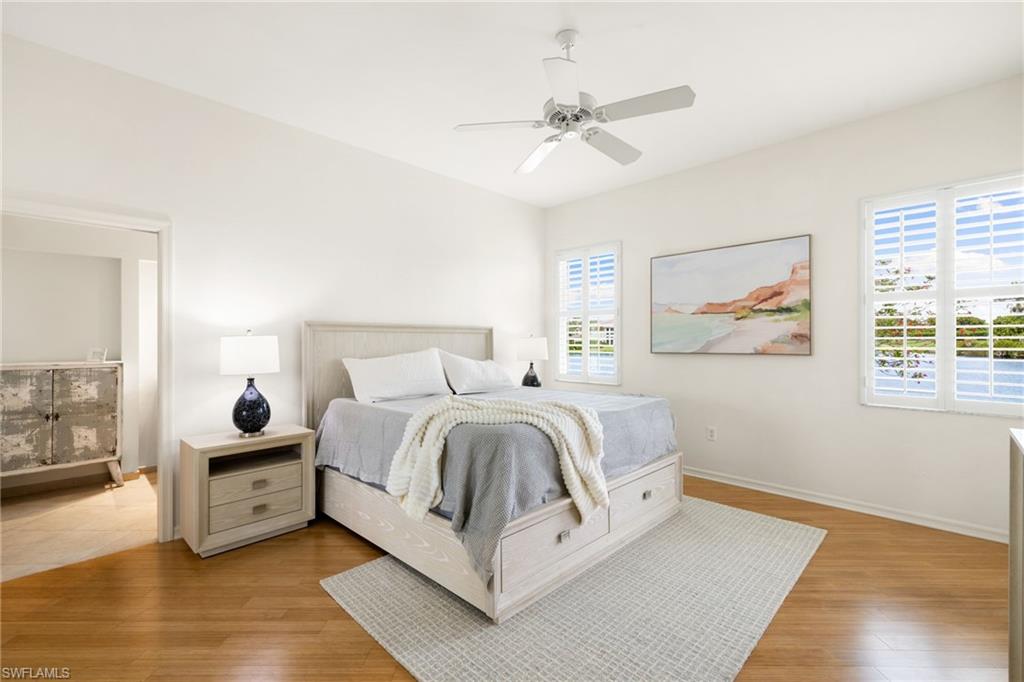 2153 Paget Circle Naples, FL 34112 - Photo 17 of 49 Bedroom with ceiling fan and light wood finished floors