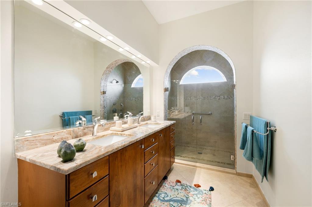 2153 Paget Circle Naples, FL 34112 - Photo 18 of 49 Bathroom with double vanity, a stall shower, and light tile patterned flooring