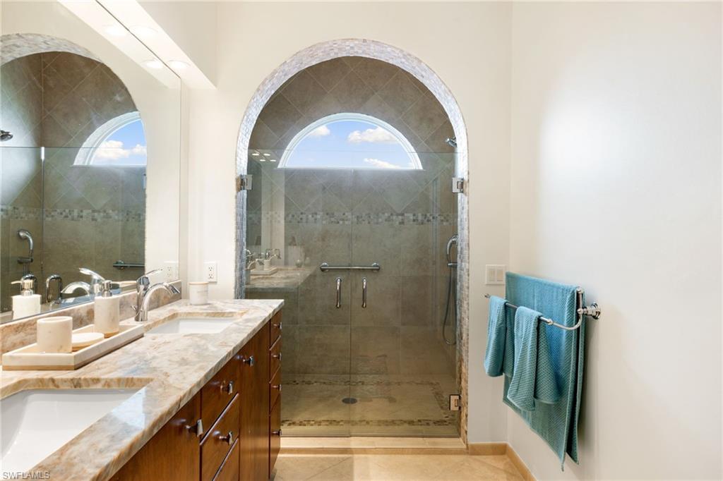 2153 Paget Circle Naples, FL 34112 - Photo 19 of 49 Full bath featuring double vanity and a shower stall