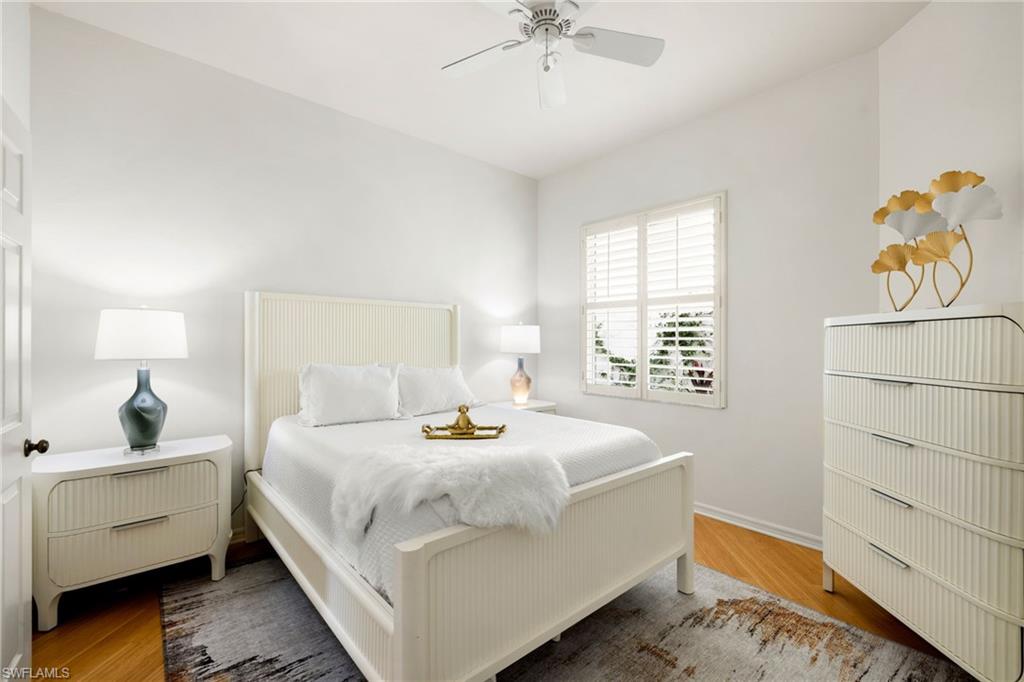 2153 Paget Circle Naples, FL 34112 - Photo 21 of 49 Bedroom with wood finished floors and ceiling fan