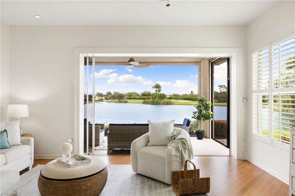 2153 Paget Circle Naples, FL 34112 - Photo 3 of 49 Living area with wood finished floors, a water view, and healthy amount of natural light
