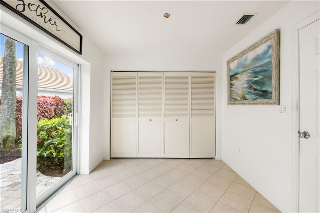 2153 Paget Circle Naples, FL 34112 - Photo 31 of 49 Unfurnished bedroom with a closet, light tile patterned floors, and access to outside