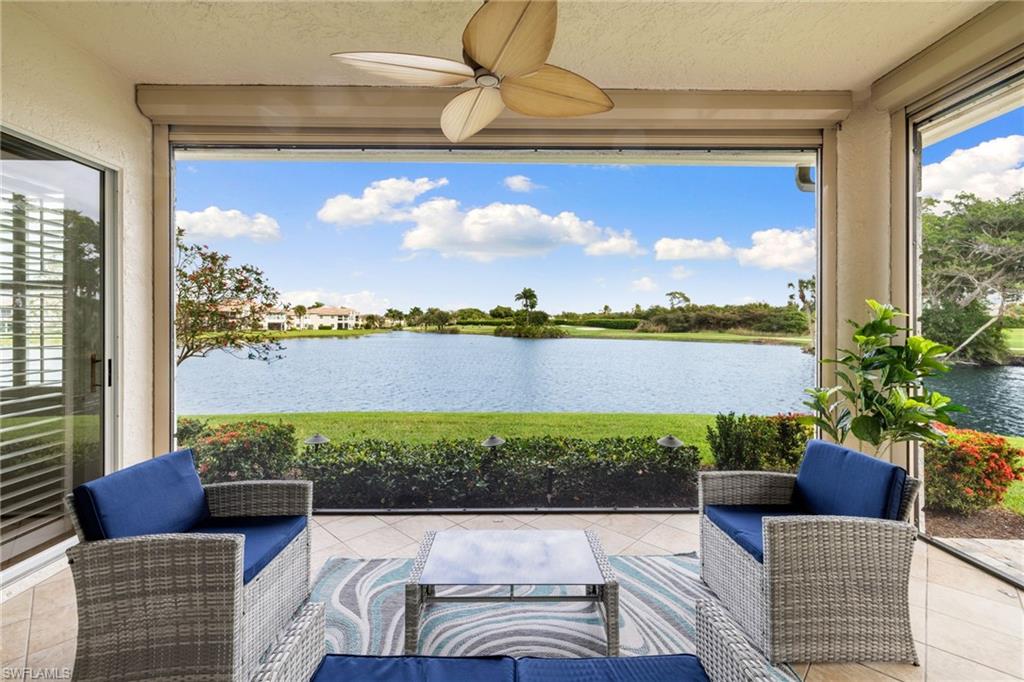 2153 Paget Circle Naples, FL 34112 - Photo 4 of 49 Sunroom / solarium with tile patterned flooring, a water view, and a textured ceiling