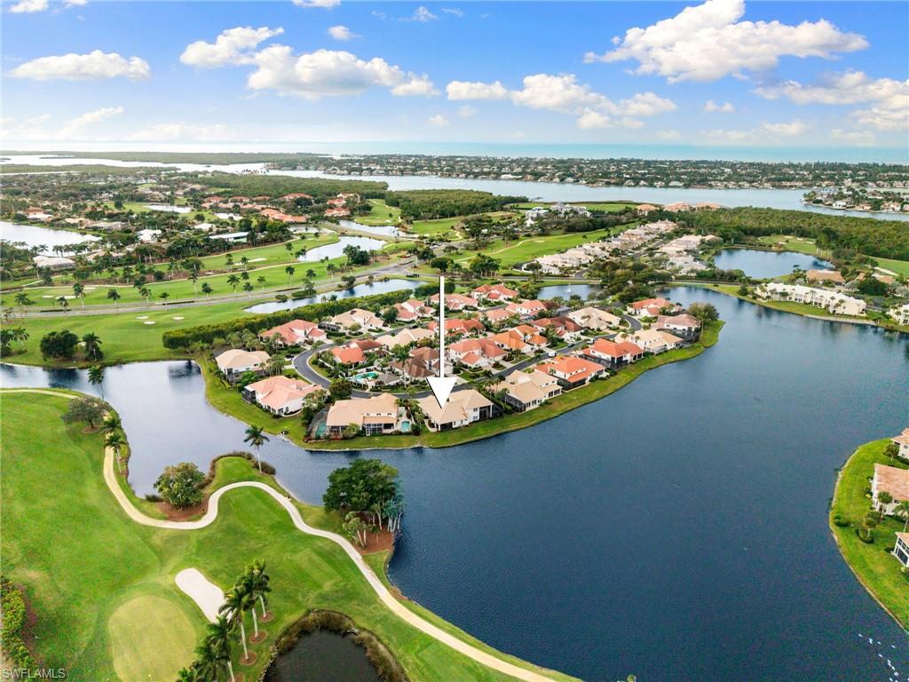 2153 Paget Circle Naples, FL 34112 - Photo 46 of 49 Aerial view of property's location featuring nearby suburban area, a golf club, and a large body of water