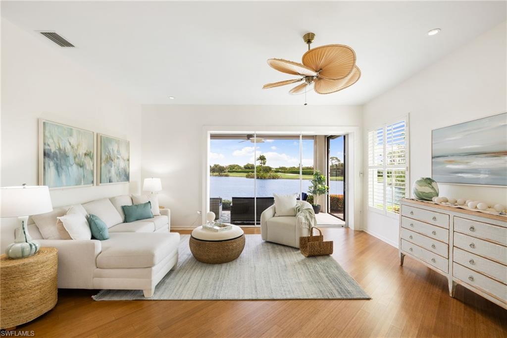 2153 Paget Circle Naples, FL 34112 - Photo 9 of 49 Living room with wood finished floors, a water view, recessed lighting, and ceiling fan