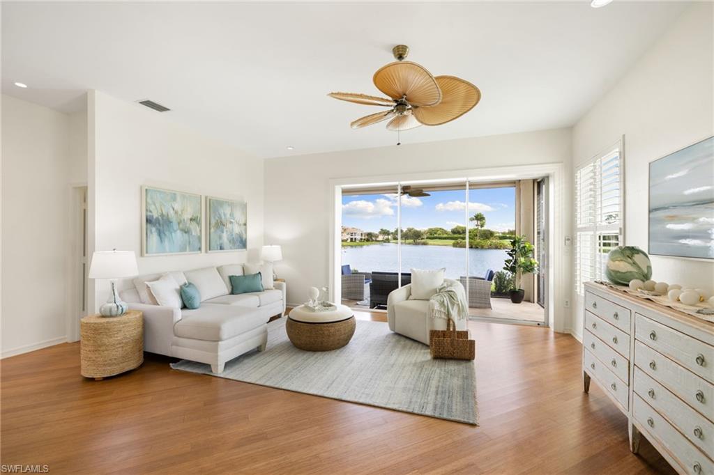 2153 Paget Circle Naples, FL 34112 - Photo 10 of 49 Living room with light wood finished floors, healthy amount of natural light, recessed lighting, and ceiling fan