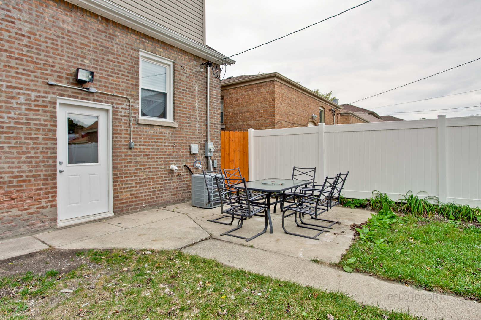 10459 South Troy Street Chicago, IL 60655 - Photo 23 of 24 a view of a patio with table and chairs and potted plants