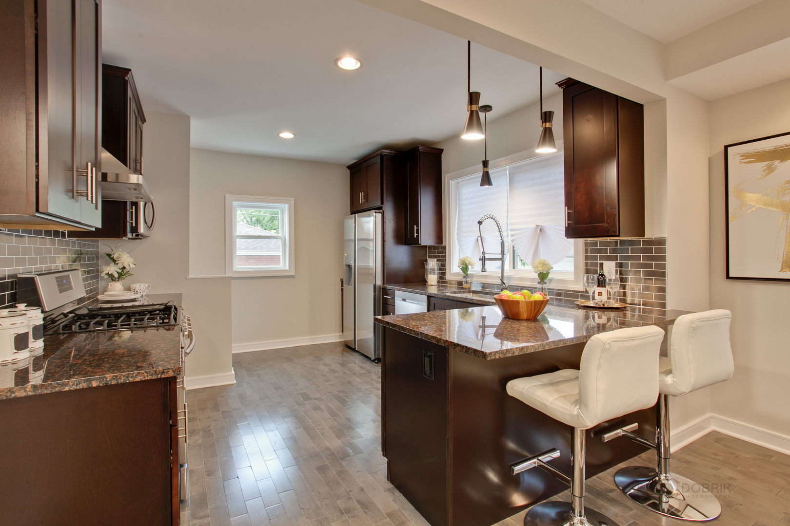 10459 South Troy Street Chicago, IL 60655 - Photo 8 of 24 a kitchen with granite countertop a sink a stove top oven a dining table and chairs