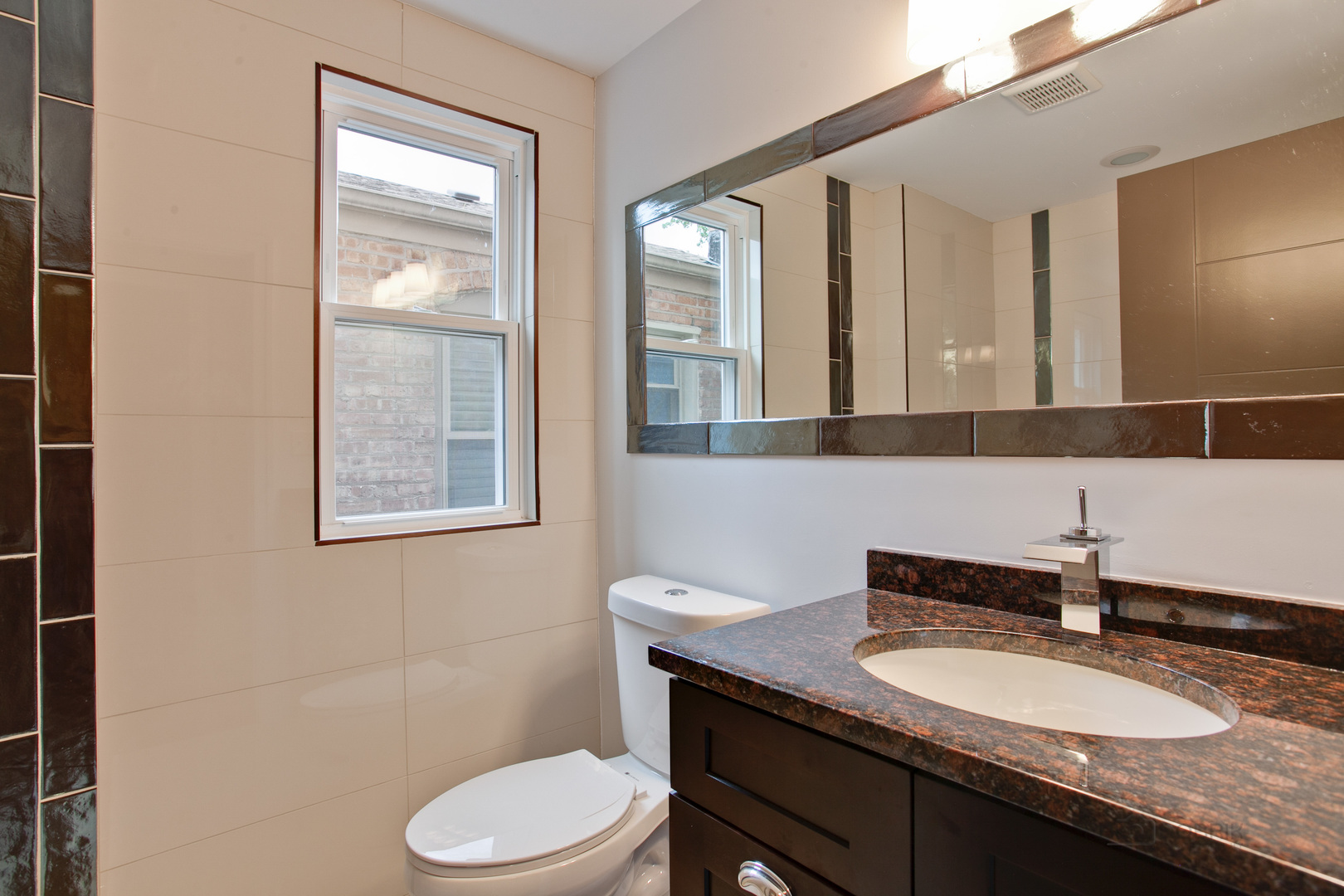 10459 South Troy Street Chicago, IL 60655 - Photo 10 of 24 a bathroom with a granite countertop toilet a sink and a mirror