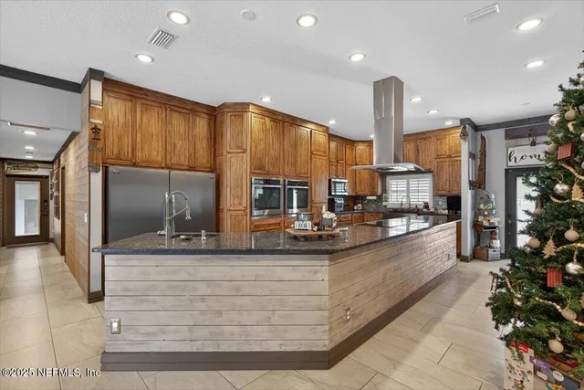 a kitchen with stainless steel appliances granite countertop a refrigerator and a sink