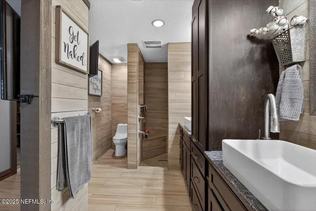 a bathroom with a sink a vanity and a mirror