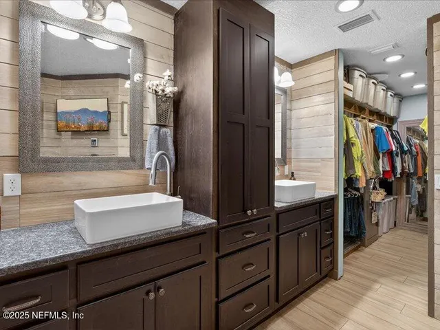 a view of a bathroom with a sink and mirror