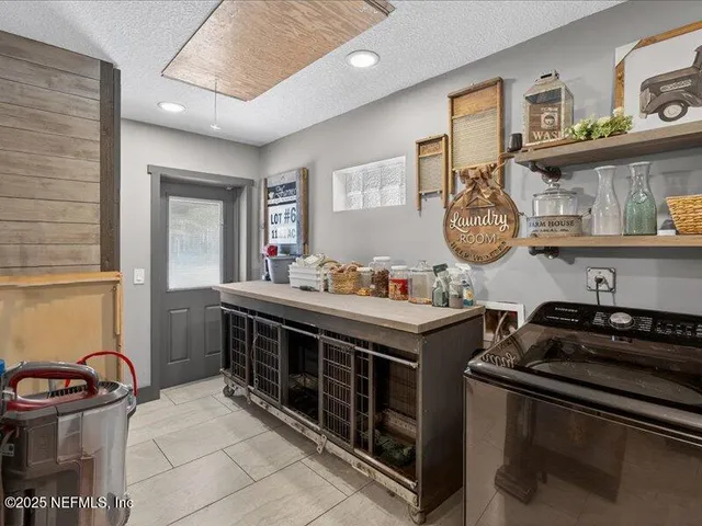 a kitchen with granite countertop a refrigerator and a stove top oven