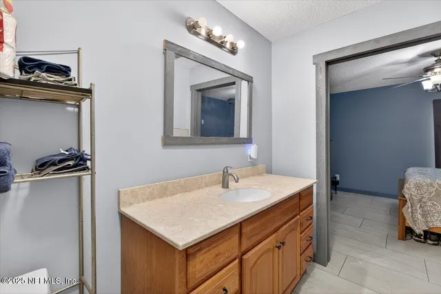 a bathroom with a sink a toilet a mirror and shower