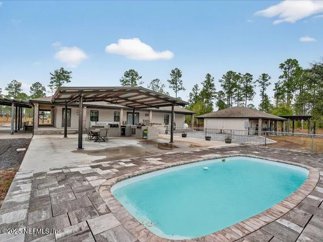 a front view of a house with a garden and patio