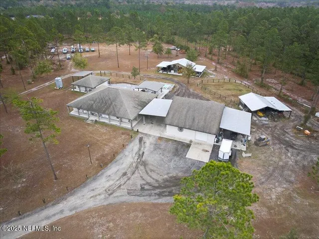 an aerial view of a house with a yard