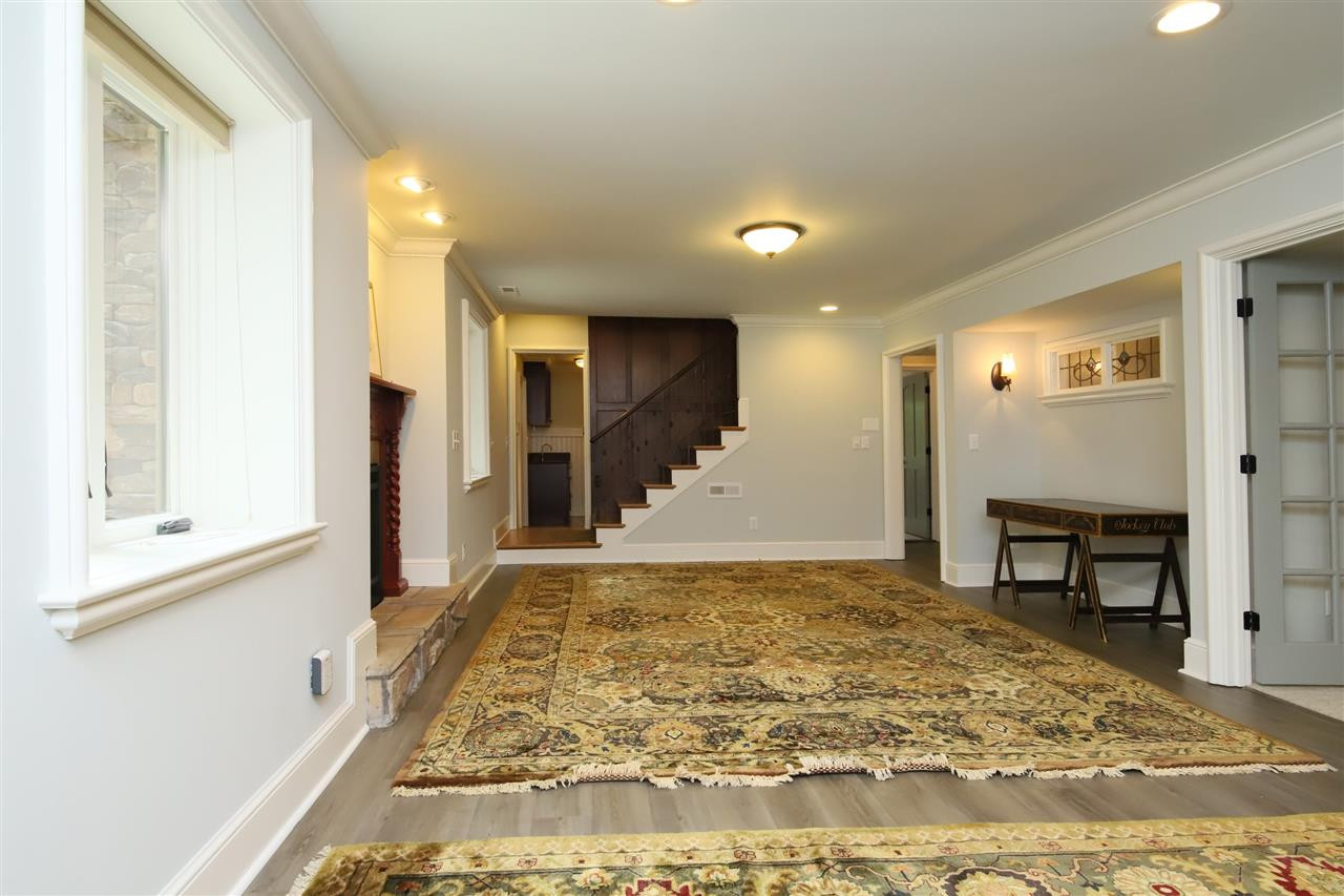 3411 Dover Road Durham, NC 27707 - Photo 18 of 29 The stairs open up onto a large family room with gas fireplace. Family Room