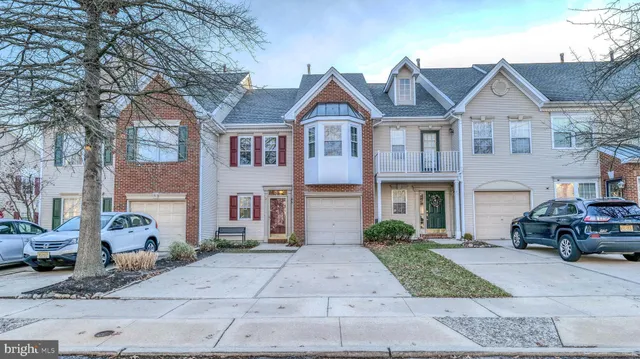 a front view of a house with a yard and potted plants