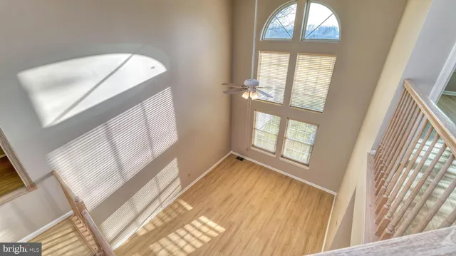 a view of a livingroom with wooden floor and a large window
