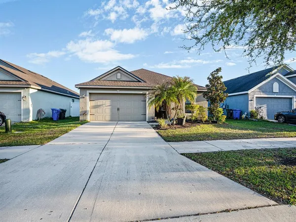 a front view of a house with a yard and garage