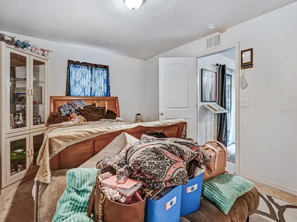 a bedroom with natural light and wooden floor