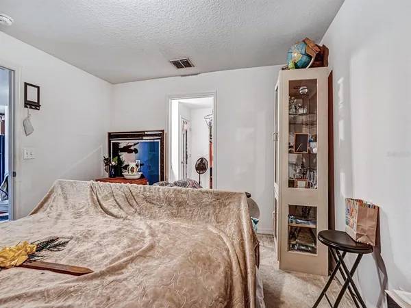 a bed room with a bed and a chair