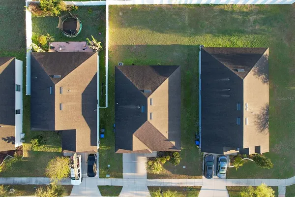 an aerial view of houses with outdoor space