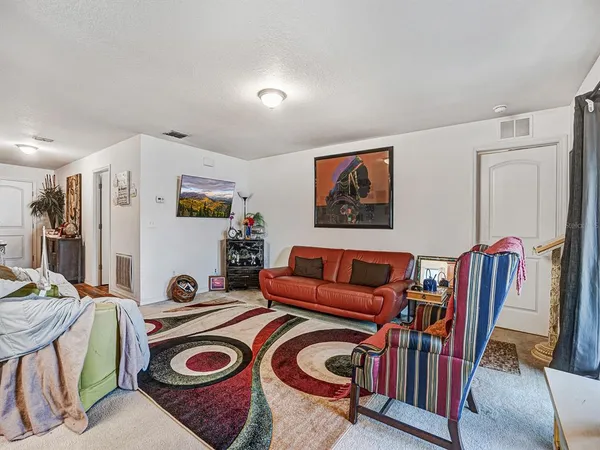 a view of a room that has a couch and a bookshelf in it