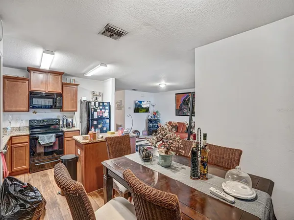 a living room with furniture and kitchen view