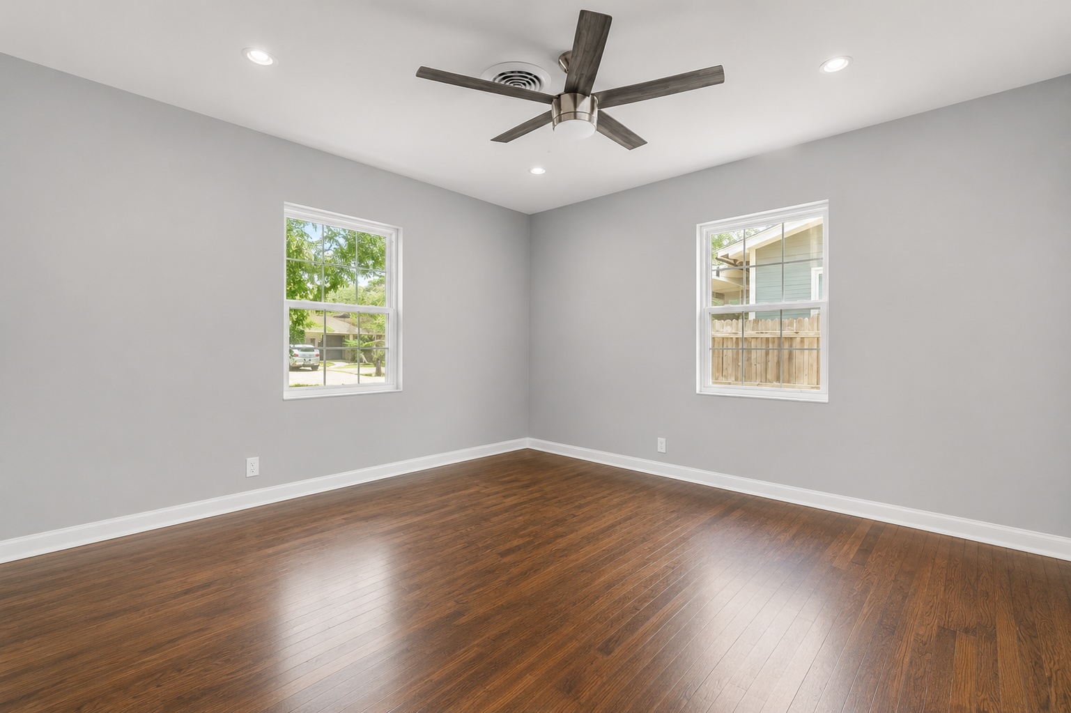 2105 Fortview Road Austin, TX 78704 - Photo 31 of 37 Rich hardwood flooring complements soft gray walls in this airy, naturally illuminated room.