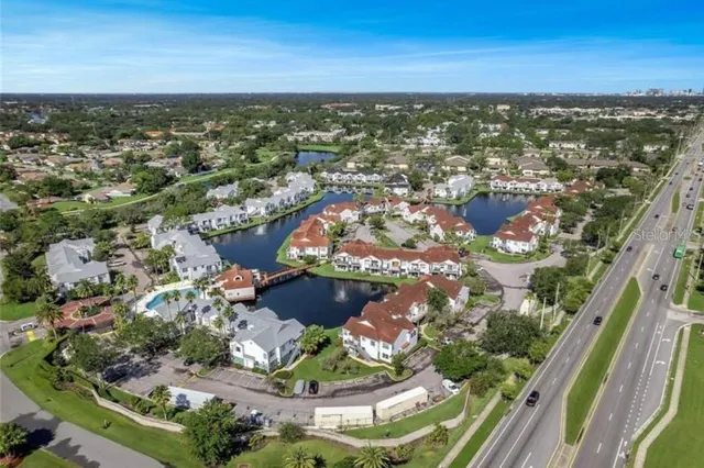 an aerial view of residential houses with outdoor space