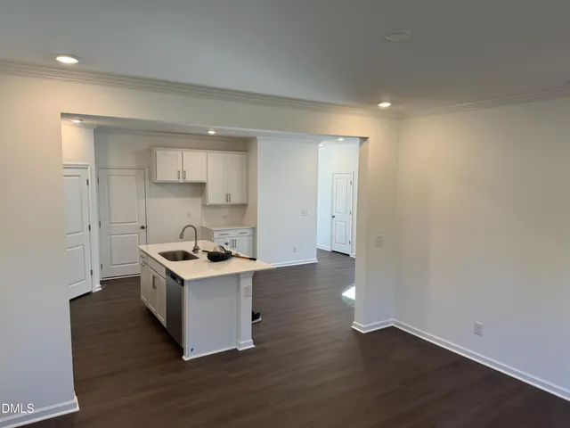 a room with wooden floor and white walls