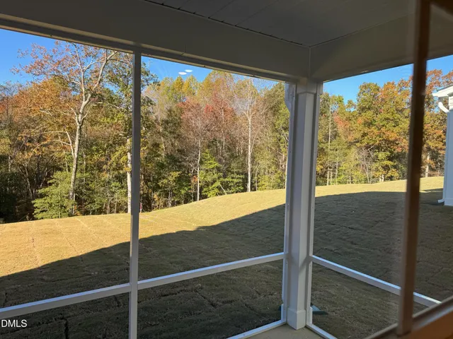 a view of a glass door with a tree
