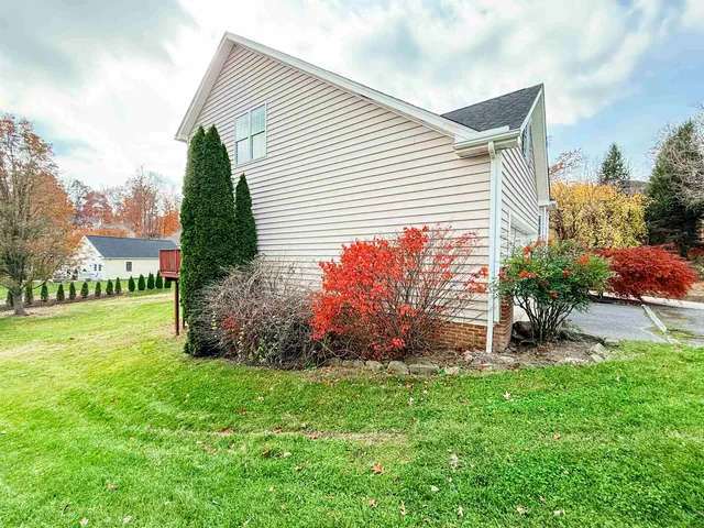 a view of a house with a yard and garden