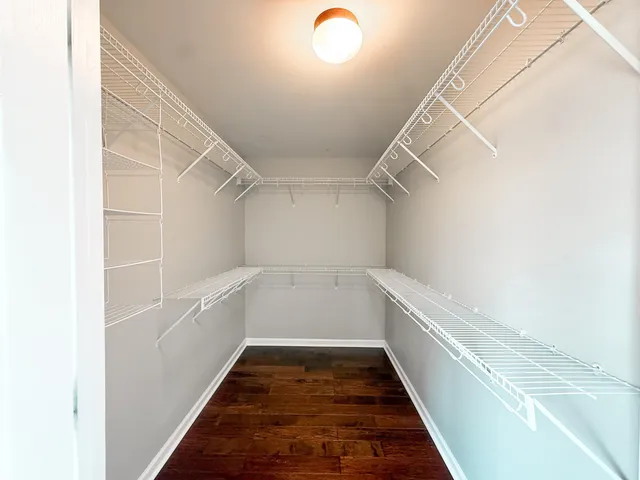 a bathroom with a double vanity sink toilet and a mirror
