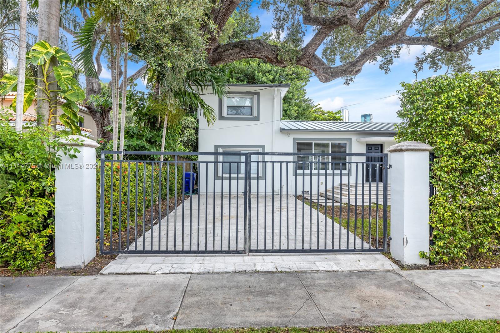 135 Southwest 22nd Road Miami, FL 33129 - Photo 1 of 44 a view of a house with a small yard and plants