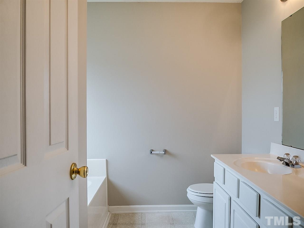 7416 Lowell Ridge Road Raleigh, NC 27616 - Photo 12 of 26 a bathroom with a sink toilet and mirror