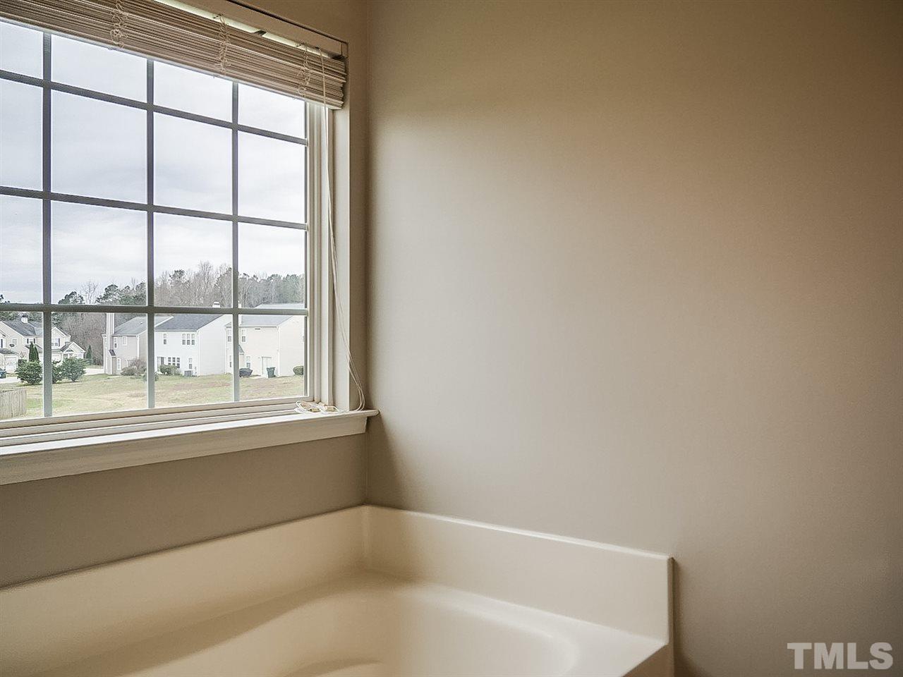 7416 Lowell Ridge Road Raleigh, NC 27616 - Photo 14 of 26 a white bath tub sitting next to a window