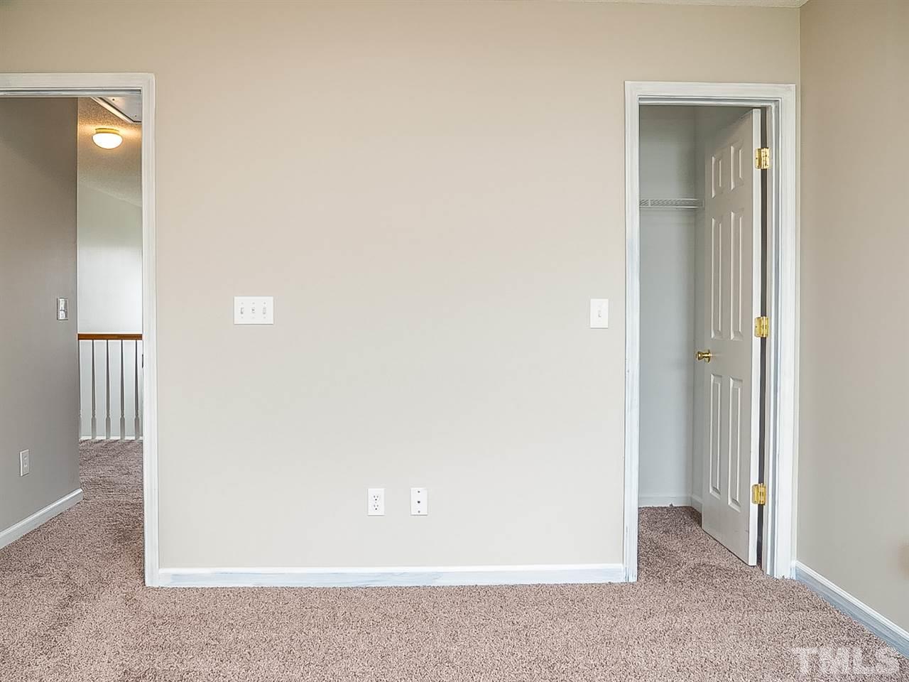 7416 Lowell Ridge Road Raleigh, NC 27616 - Photo 16 of 26 an empty room with closet and mirror